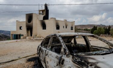A destroyed car sits outside a burnt house after Israeli settlers attacked the Tubasi family and Israeli security forces who were escorting them back to their home in Jalud.