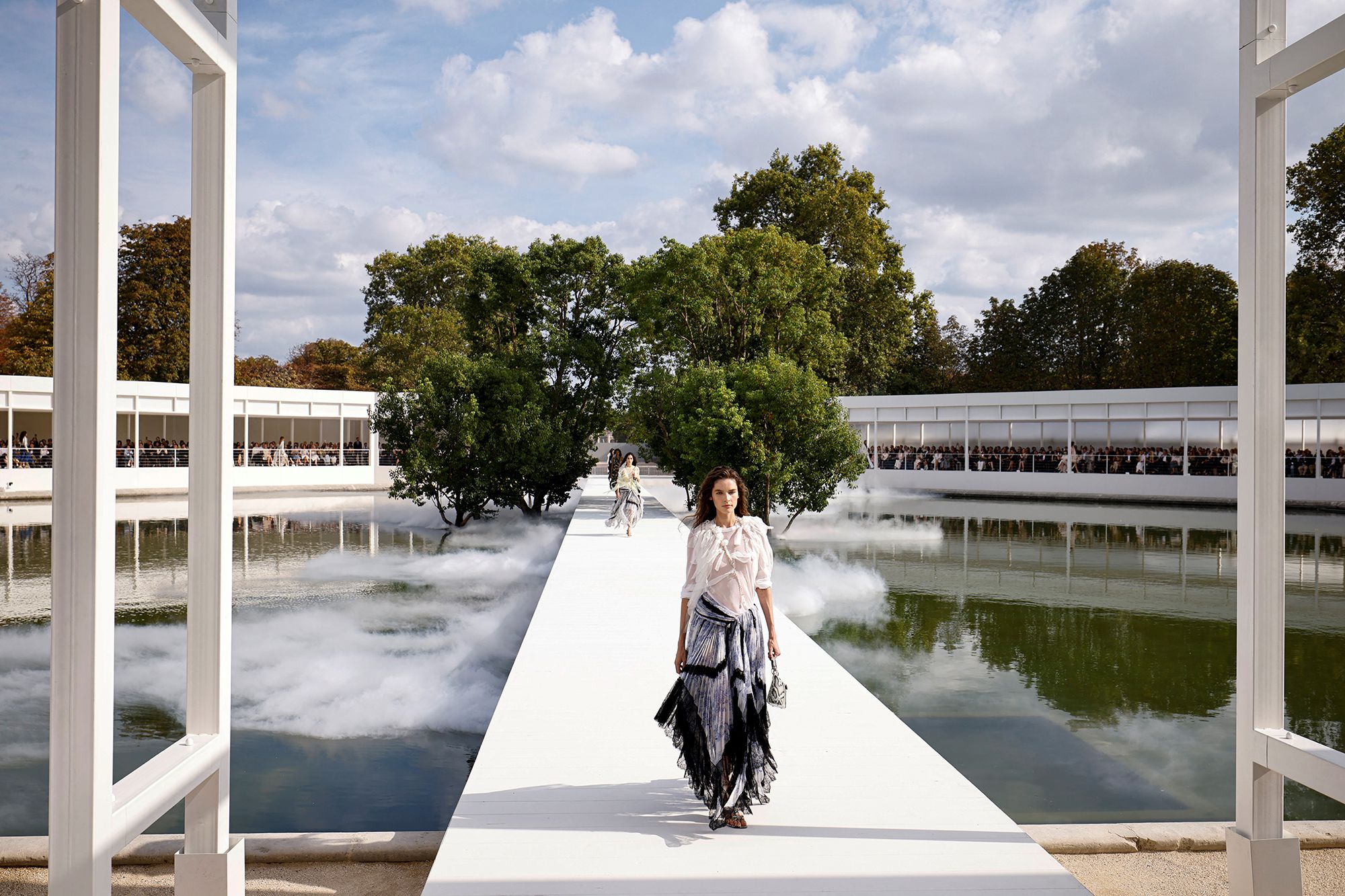 <i>Simon Wohlfahrt/AFP/Getty Images via CNN Newsource</i><br/>Models floated above a misty circular pond at Dior.