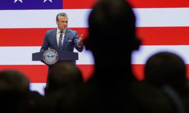 Members of the military listen as US Secretary of Defense Pete Hegseth gives an address at Marine Corps Base Quantico on September 30 in Quantico