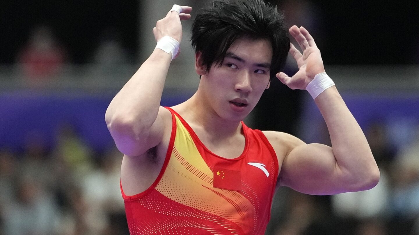 Zhang Boheng of team China reacts after the floor exercise competition of men's team final of Artistic Gymnastics at the 20th Asian Games Aichi-Nagoya 2026 in Nagoya