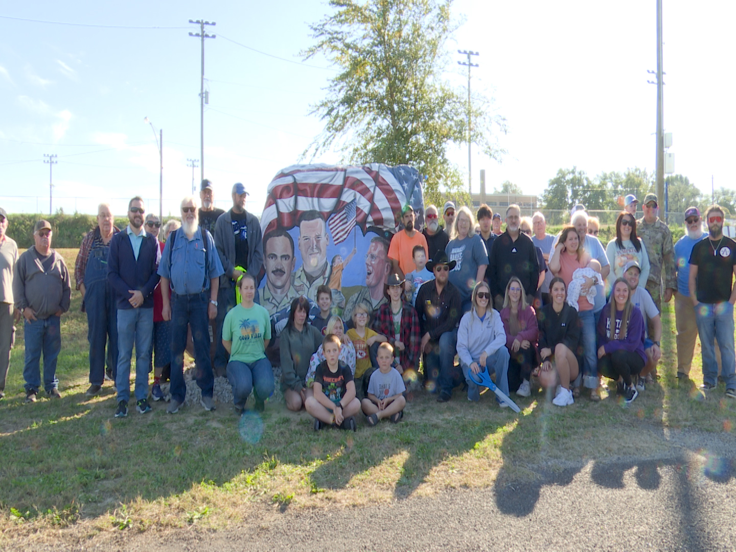 Attendees pose in front of the new Freedom Rock in Troy