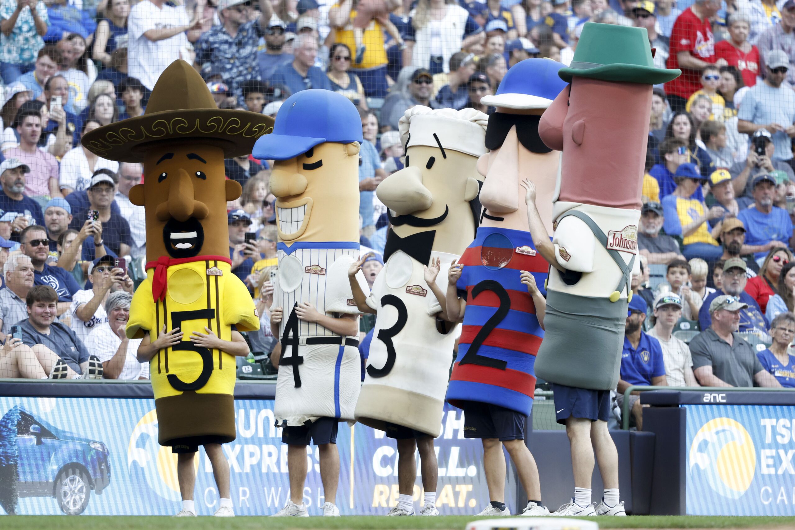 <i>Dylan Buell/Getty Images via CNN Newsource</i><br/>A fan gets a picture with one of the racing sausages in 2017.