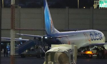 People disembark from a FlyDubai carrying Israeli passengers who had earlier been aboard another FlyDubai aircraft that made an emergency landing in Saudi Arabia approaches Ben Gurion International Airport near Tel Aviv