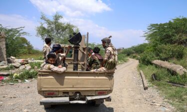 Saudi-backed Yemen government soldiers ride in a pick-up truck near the Jabal Han front