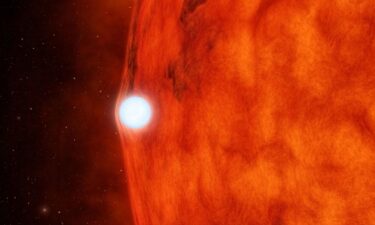 An artist's depiction of a white dwarf passing in front of a small red star.