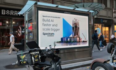 An AI advertisement is displayed near the New York Stock Exchange on September 14