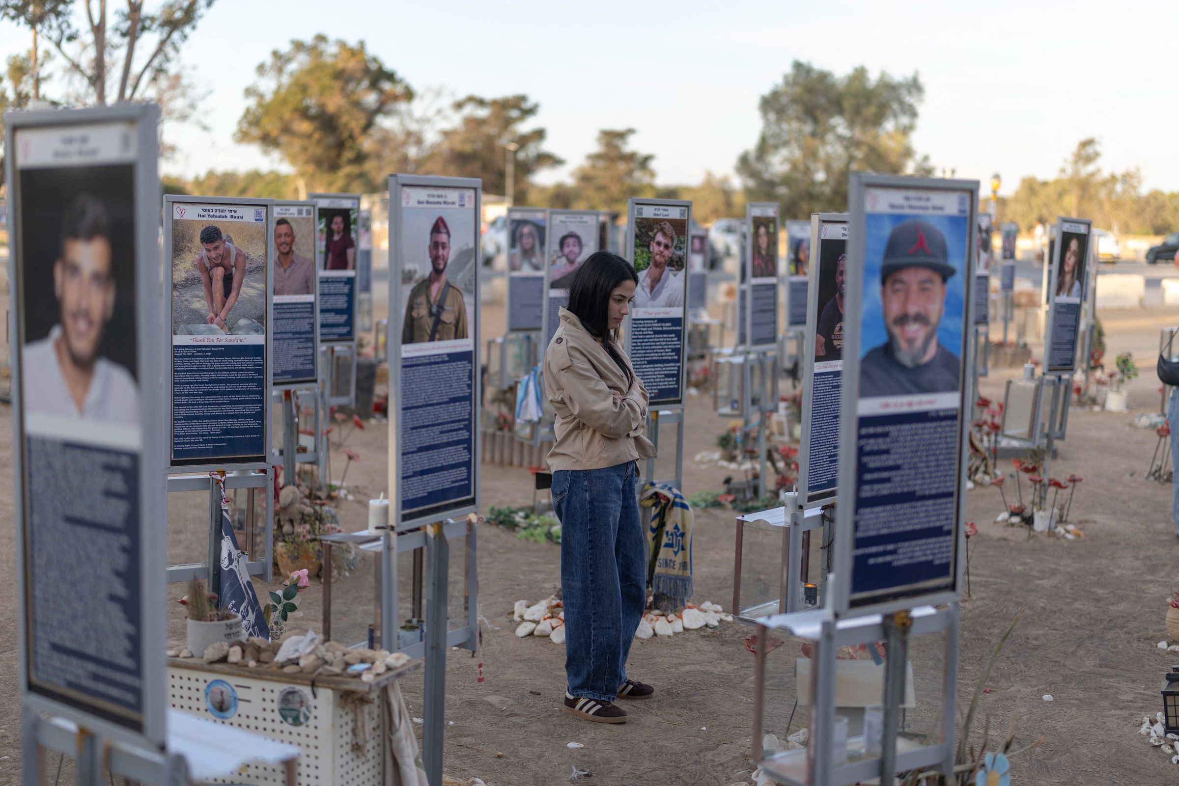 <i>Ilia Yefimovich/AFP/Getty Images via CNN Newsource</i><br/>An Israeli woman pays her respects at a memorial to the victims of the 2023 Hamas attacks at the Nova festival site in Reim