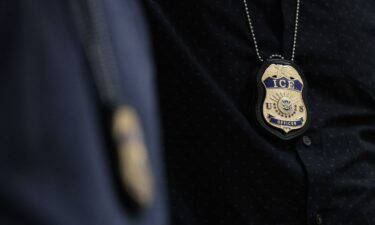 The badges of Immigration and Customs Enforcement agents are seen as they patrol the halls of an immigration court in New York in May.