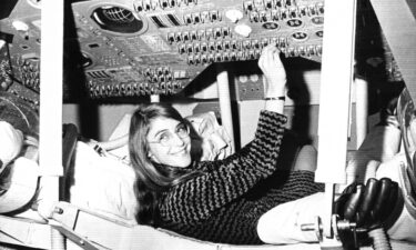 Margaret Hamilton sits in mock-up of an Apollo command module on display at the Cambridge school