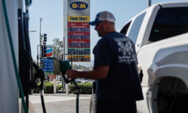 A sign displays the prices of unleaded gasoline and diesel fuel as a driver refuels a vehicle at a G&M gas station in Torrance