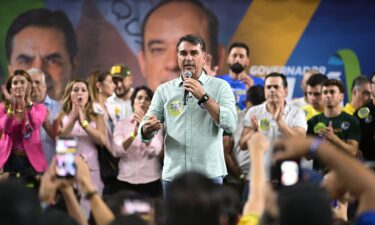 Brazilian right-wing presidential candidate Flavio Bolsonaro holds a picture of his father