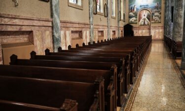 A worshipper kneels in St. Paul's Chapel