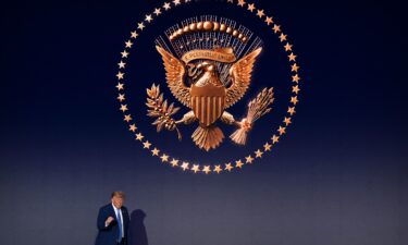 President Donald Trump walks across the stage during an event to mark the launch of the America.gov website on September 29