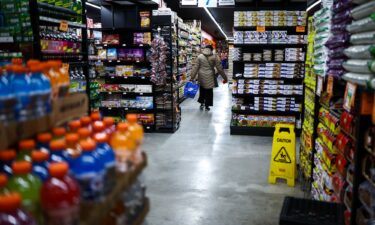 A customer walks down the aisle in a supermarket in the Sugar Hill neighborhood of Manhattan in New York on September 28