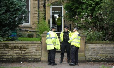 Police attend an address in Manchester on September 21