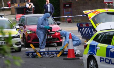 Forensic police officers photograph the scene where two people were stabbed in an antisemitic attack in April in London.
