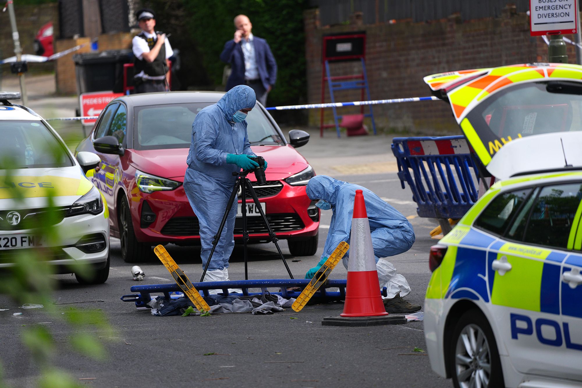 <i>Carl Court/Getty Images via CNN Newsource</i><br/>Forensic police officers photograph the scene where two people were stabbed in an antisemitic attack in April in London.