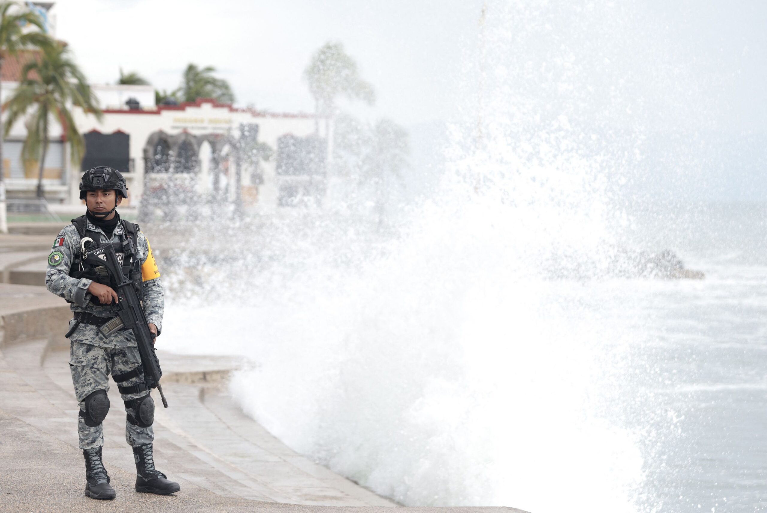 <i>Ulises Ruiz/AFP/Getty Images via CNN Newsource</i><br/>A member of Mexico's National Guard stands on the Puerto Vallarta boardwalk as waves crash against the shoreline ahead of the potential impact of Hurricane Simon in Puerto Vallarta