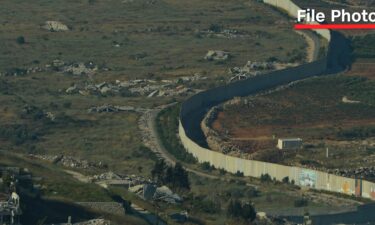 A border wall erected by Israel along its northern border with Lebanon is seen between Metulla in Israel to the right and Odaisseh in Lebanon to the left on June 19.