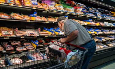 A shopper searches for meat products at a supermarket in Colebrook