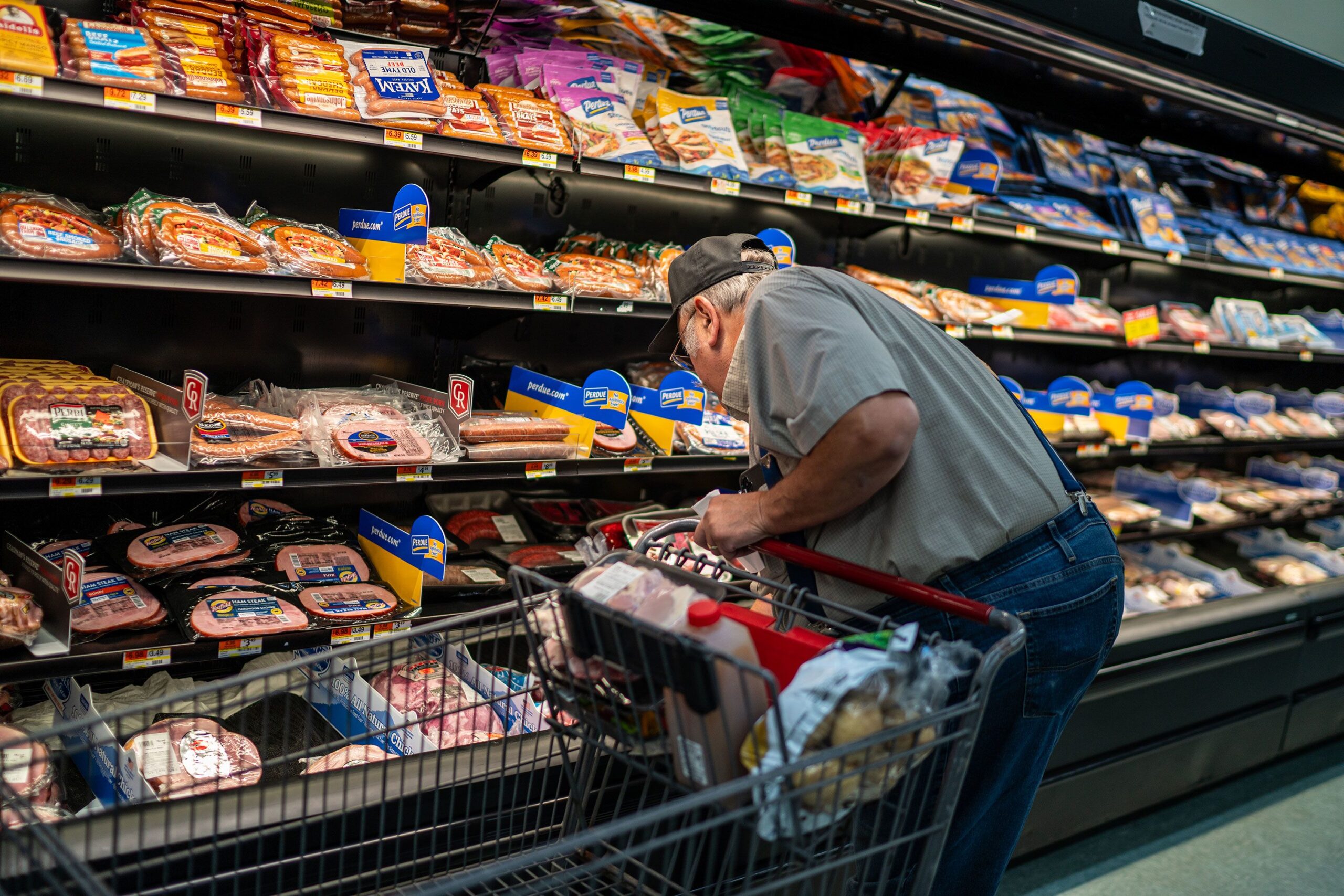 <i>Robert Nickelsberg/Getty Images via CNN Newsource</i><br/>A shopper searches for meat products at a supermarket in Colebrook