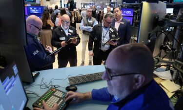 Traders work on the floor of the New York Stock Exchange during morning trading on October 14