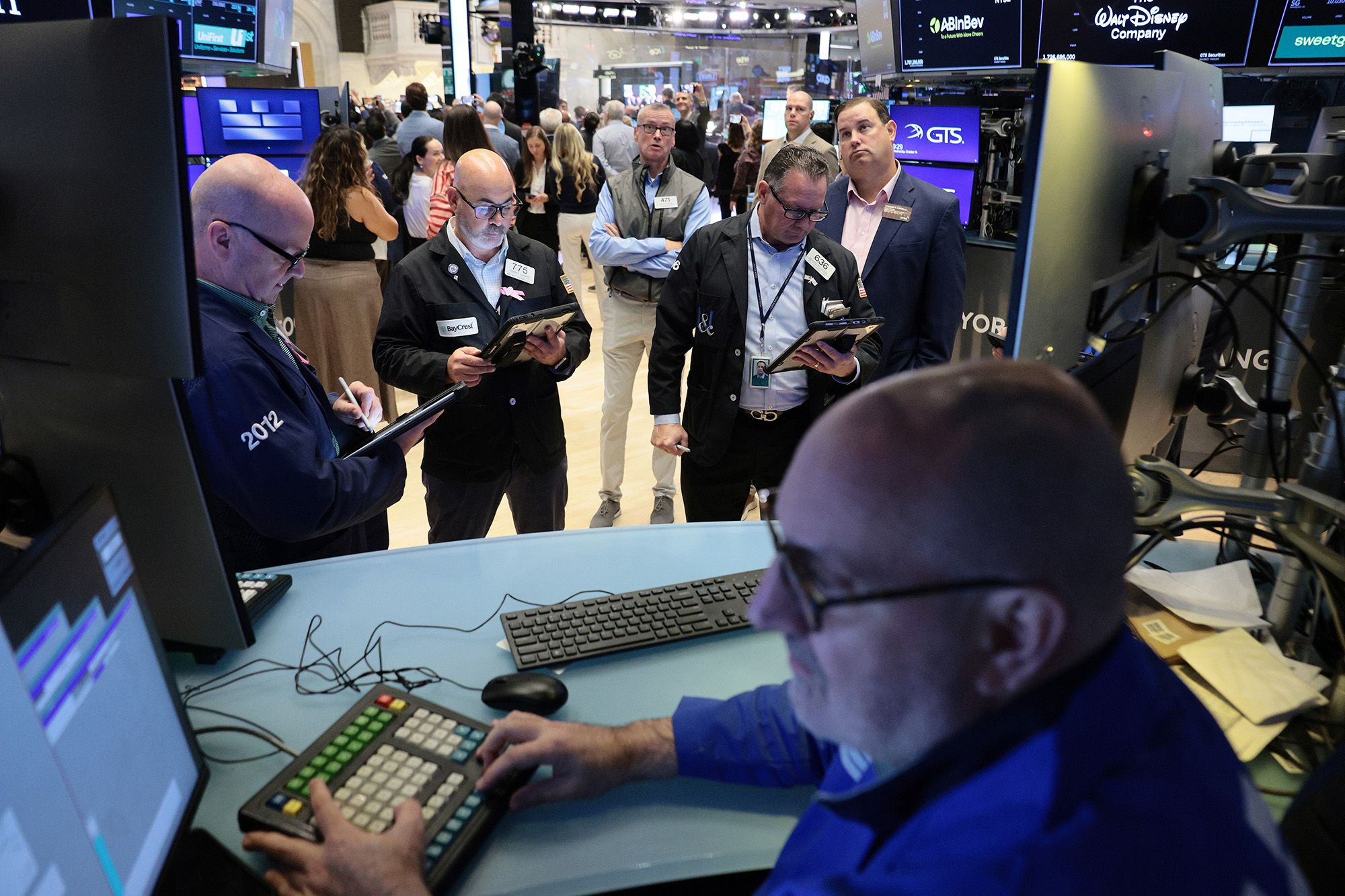 <i>Michael M. Santiago/Getty Images via CNN Newsource</i><br/>Traders work on the floor of the New York Stock Exchange during morning trading on October 14