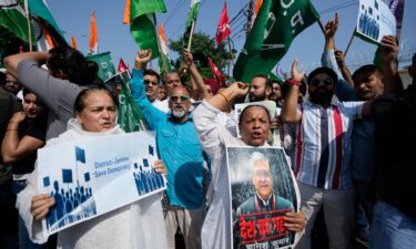 Supporters of India's opposition parties hold placards as they march demanding the resignation of the country's election chief Gyanesh Kumar in Jammu