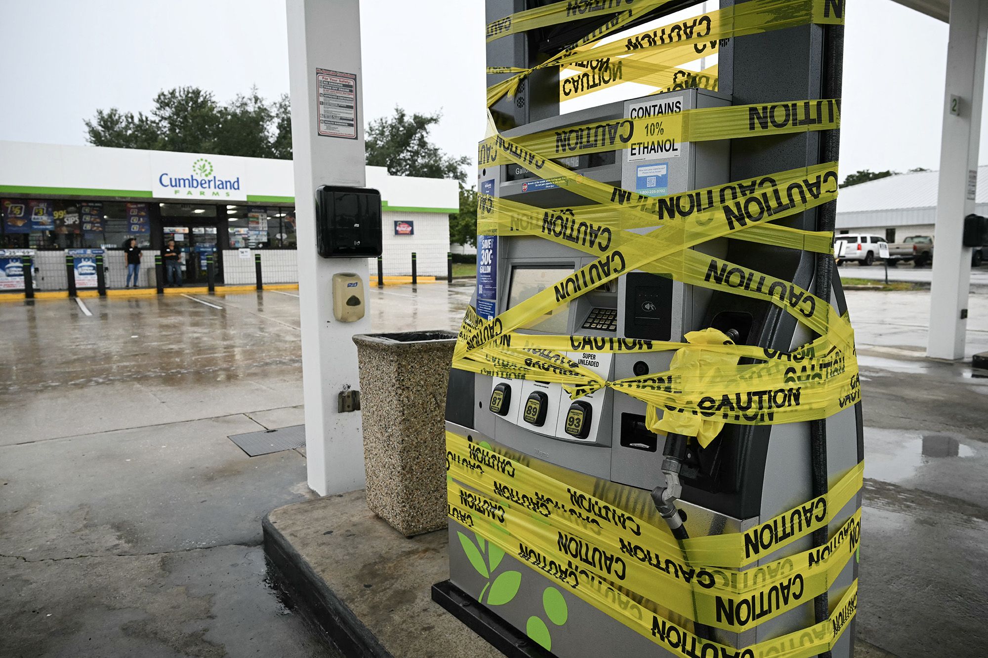 <i>Ronaldo Schemidt/AFP/Getty Images via CNN Newsource</i><br/>Workers cordon off a gas pump with yellow tape at a gas station in Navarre
