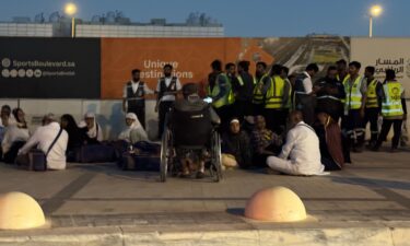 People gather outside a metro station on the road to King Khalid International Airport in Riyadh