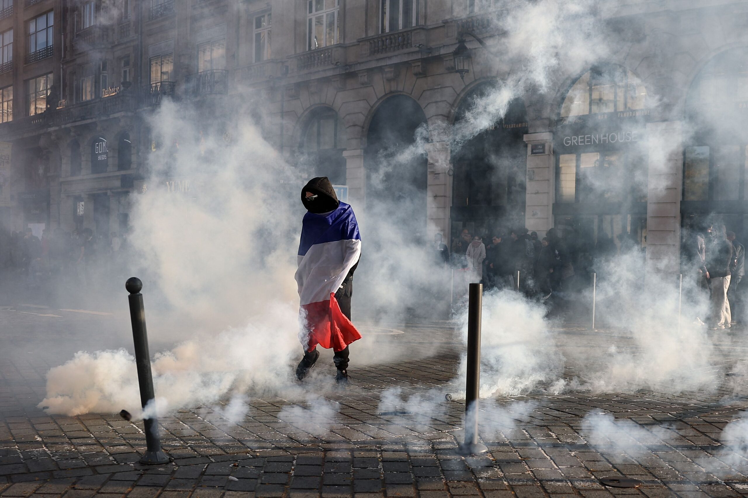 <i>Aris Messinis/AFP/Getty Images via CNN Newsource</i><br/>Protesters inside a bar face riot mobile gendarmes near Porte de Vincennes during a demonstration in Paris