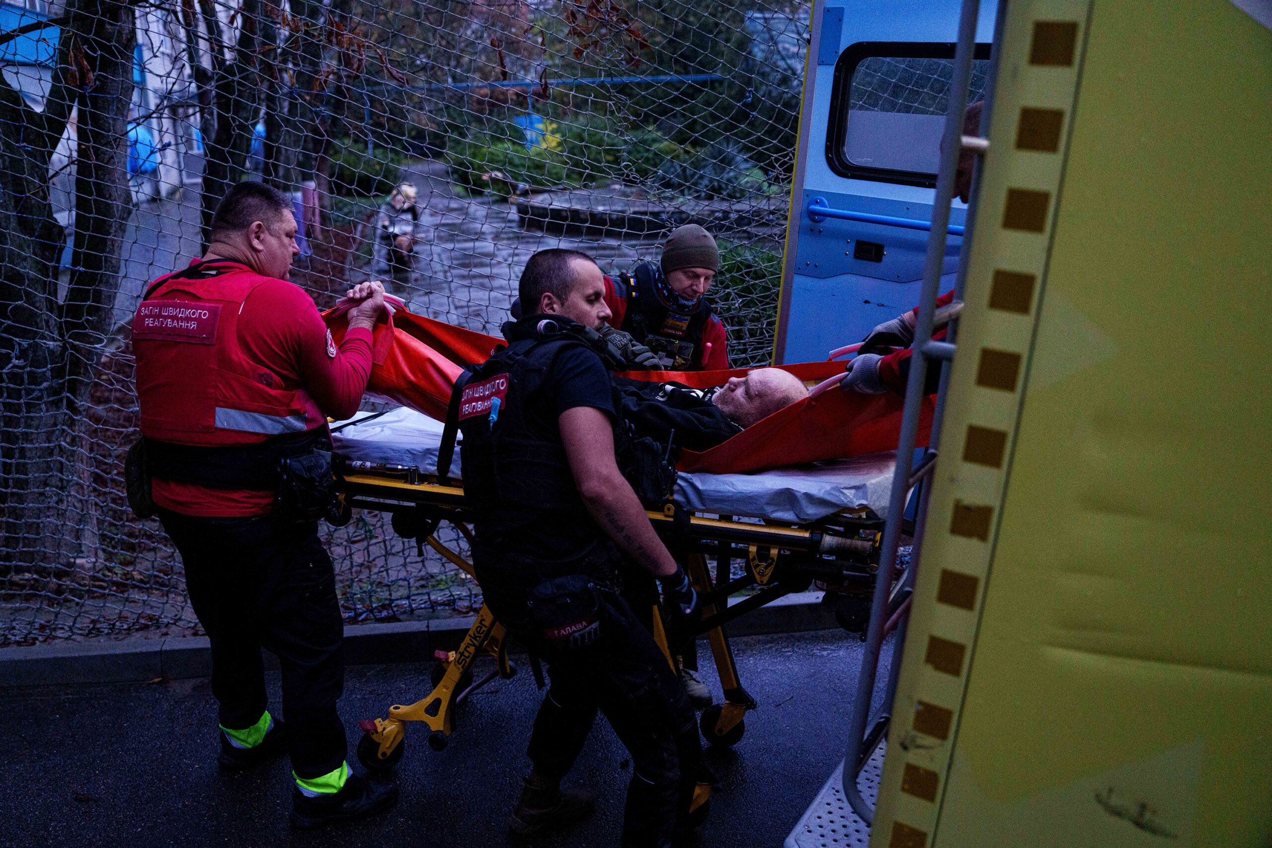 <i>Evgeniy Maloletka/AP via CNN Newsource</i><br/>Red Cross volunteers move a man on a stretcher into an ambulance during an evacuation mission in Oleshky