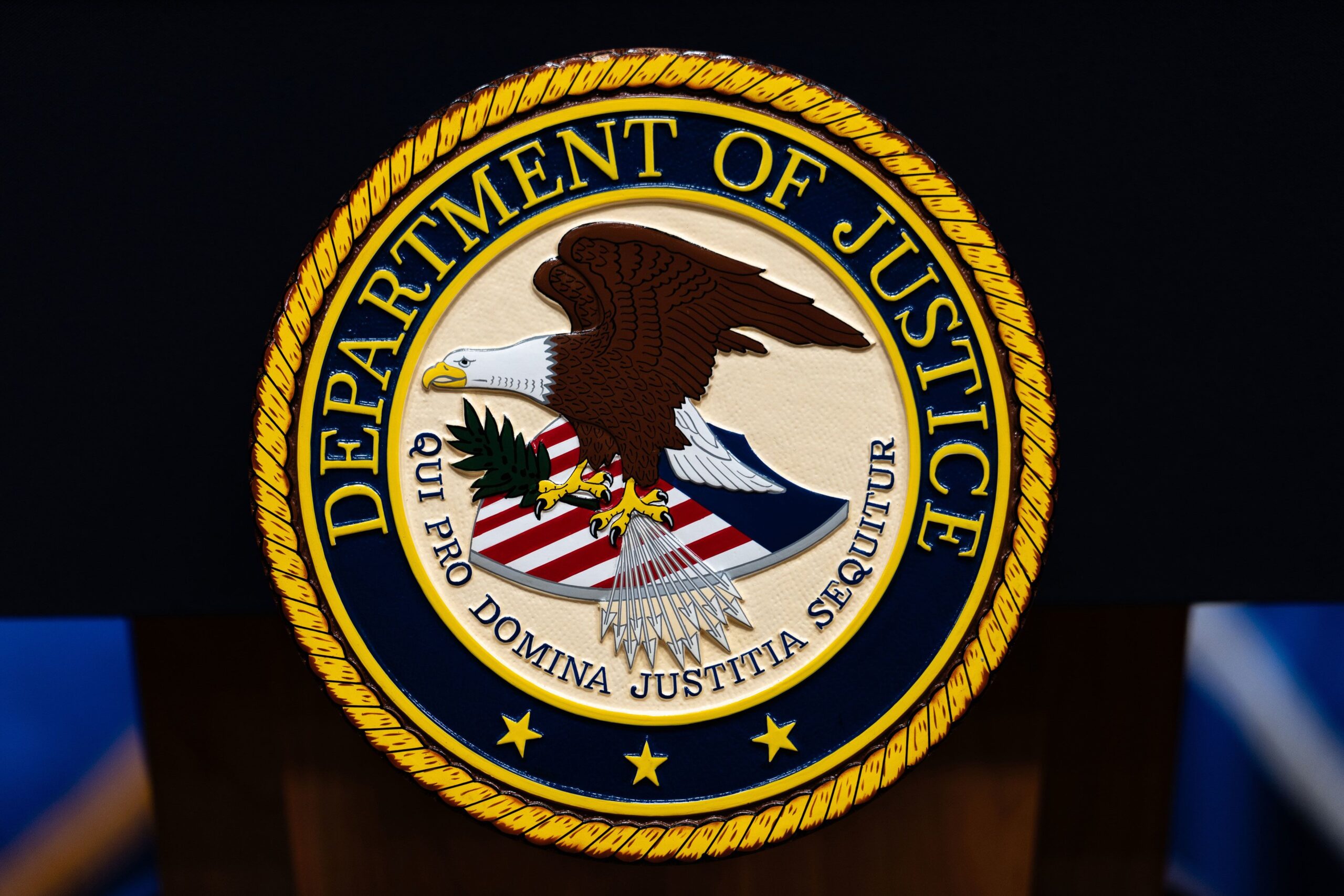 <i>Julia Demaree Nikhinson/AP via CNN Newsource</i><br/>The US Department of Justice logo is seen on a podium before a news conference