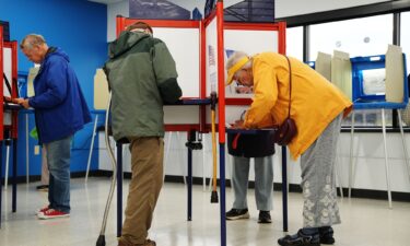 Voters cast their ballots on the first day of early voting in Minnesota at the Elections & Voter Services building in Minneapolis on September 18.