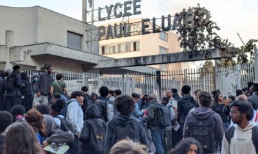 Students gather in front of barricaded gates at the Lycee Paul-Eluard high school in the northern Paris suburb of Saint-Denis