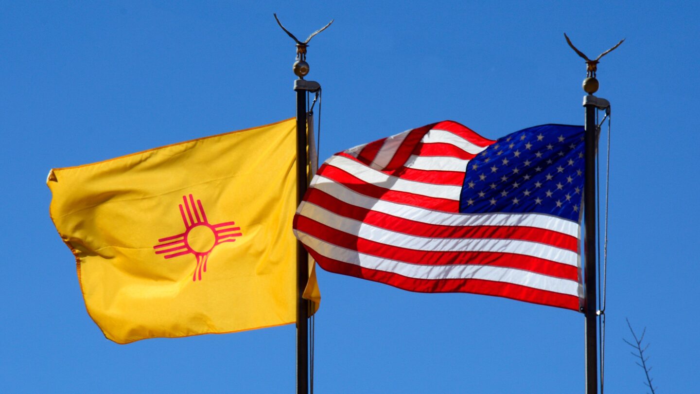 <i>Robert Alexander/Getty Images/File via CNN Newsource</i><br/>The New Mexico state flag and the American flag fly side-by-side in Santa Fe
