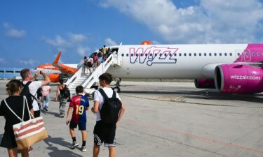 Passengers embark a Wizz air jet at the Lampedusa airport