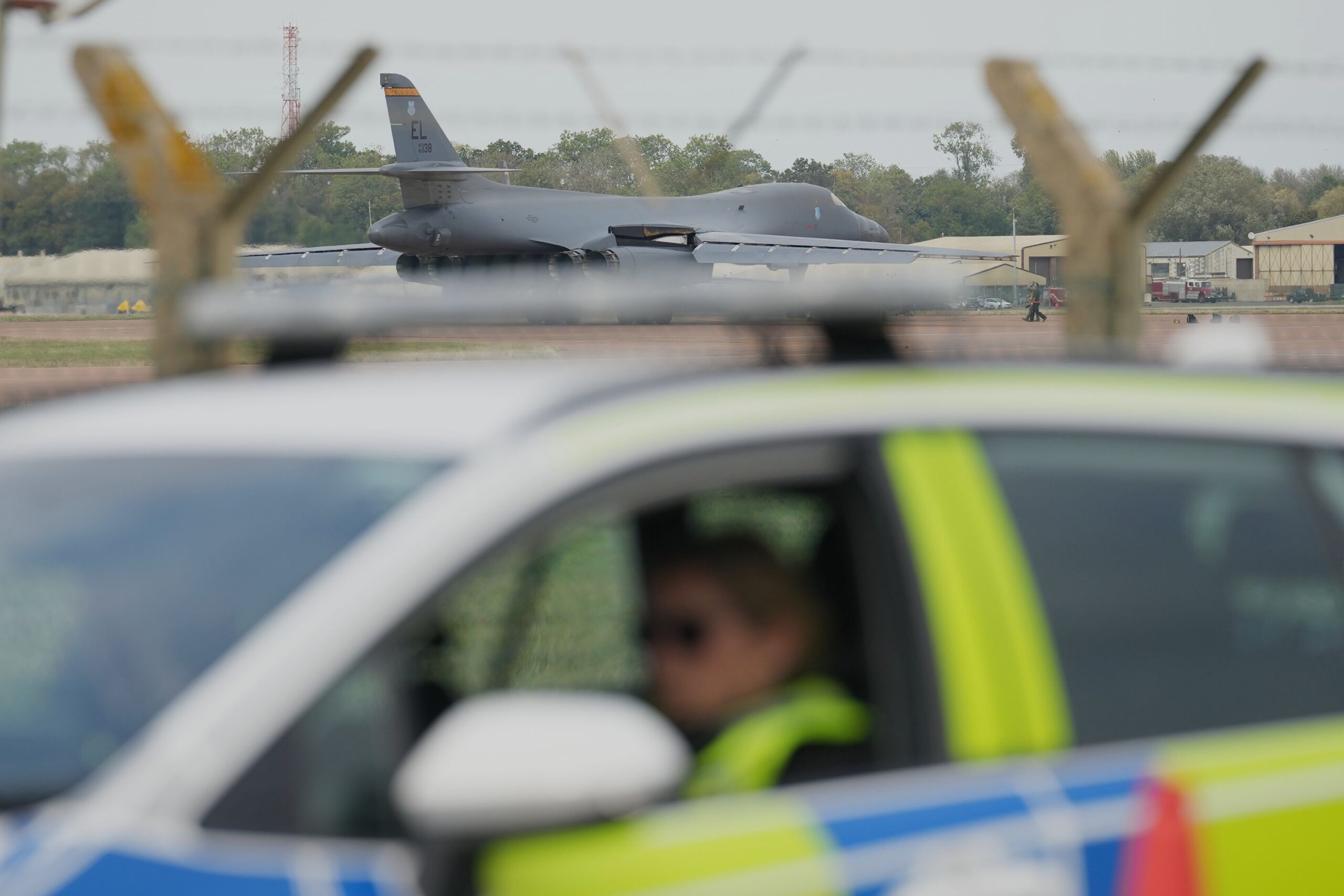<i>Alastair Grant/AP via CNN Newsource</i><br/>A B1 bomber prepares to take off as police officers guard a checkpoint near RAF Fairford in Fairford