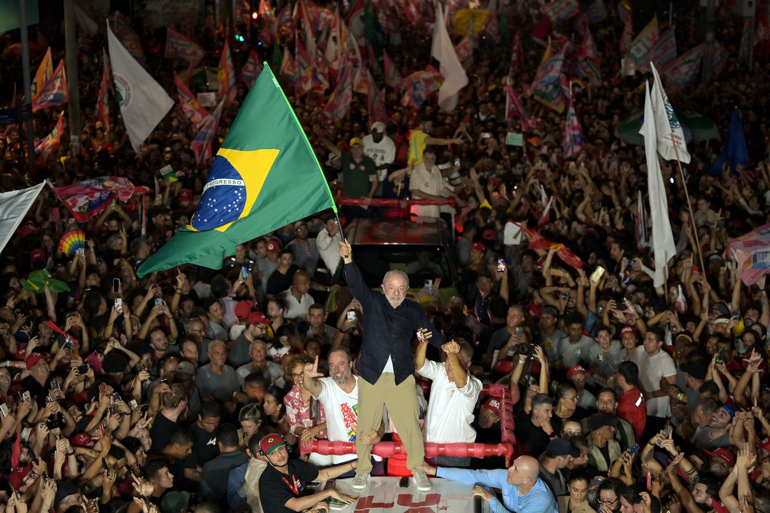 <i>Eraldo Peres/AP via CNN Newsource</i><br/>A street vendor arranges campaign flags for sale featuring Brazilian President Luiz Inacio Lula da Silva