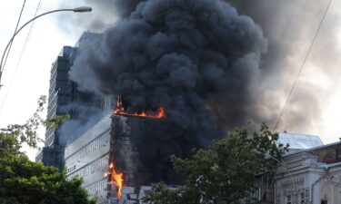 Electricians work to restore the power grid in front of a destroyed private house in the Kyiv region. A a 14-year-old was killed in the attack on September 30.