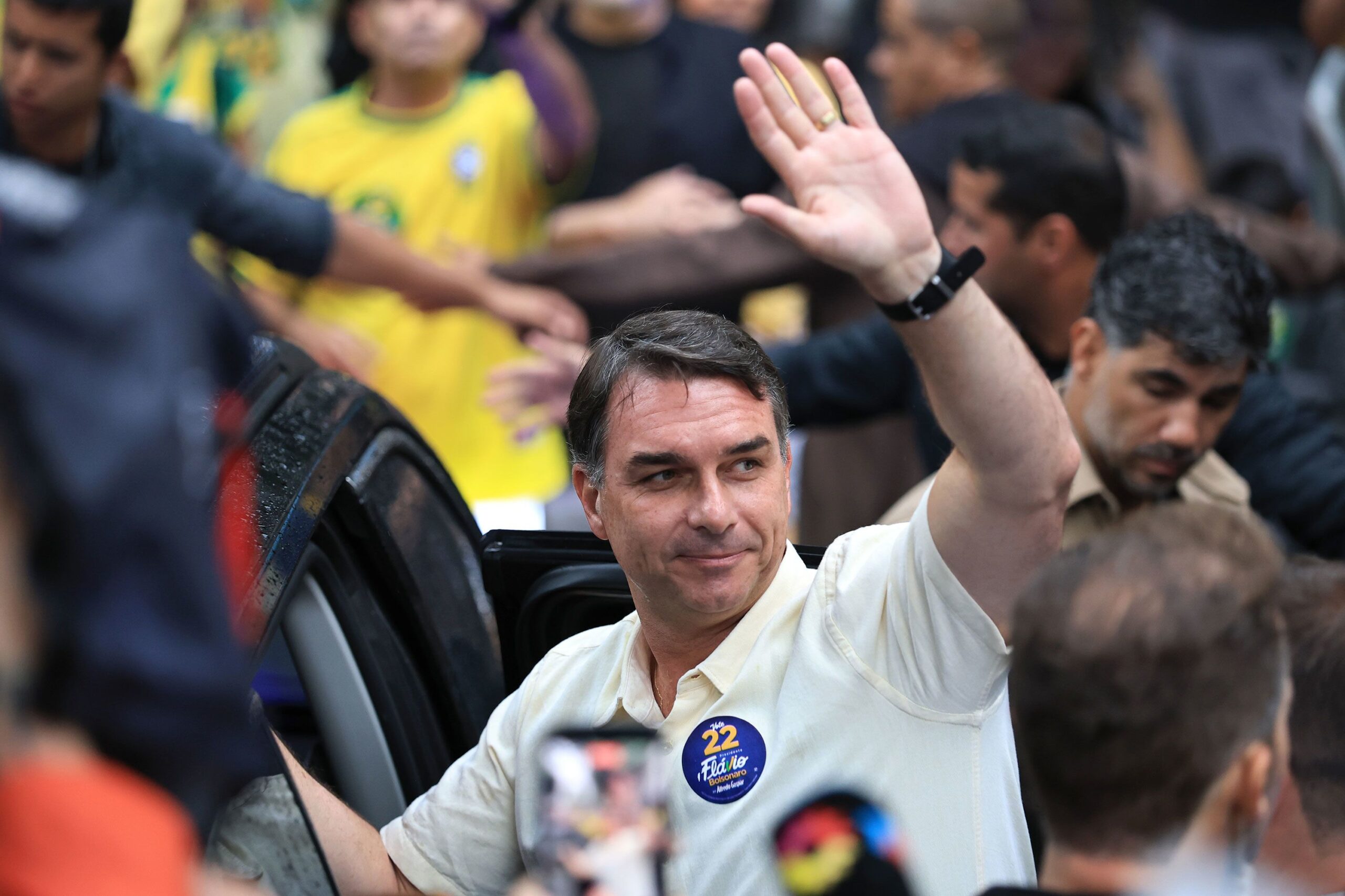 <i>Buda Mendes/Getty Images via CNN Newsource</i><br/>Flávio Bolsonaro waves after casting his vote in Rio de Janeiro on Sunday.