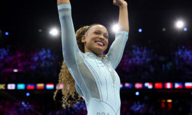 Rebeca Andrade waves and celebrates