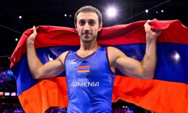 Artur Davtyan holds up Armenia flag behind him in celebration