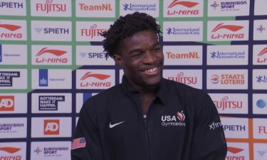 Frederick Richard stands in front of a step-and-repeat during an interview