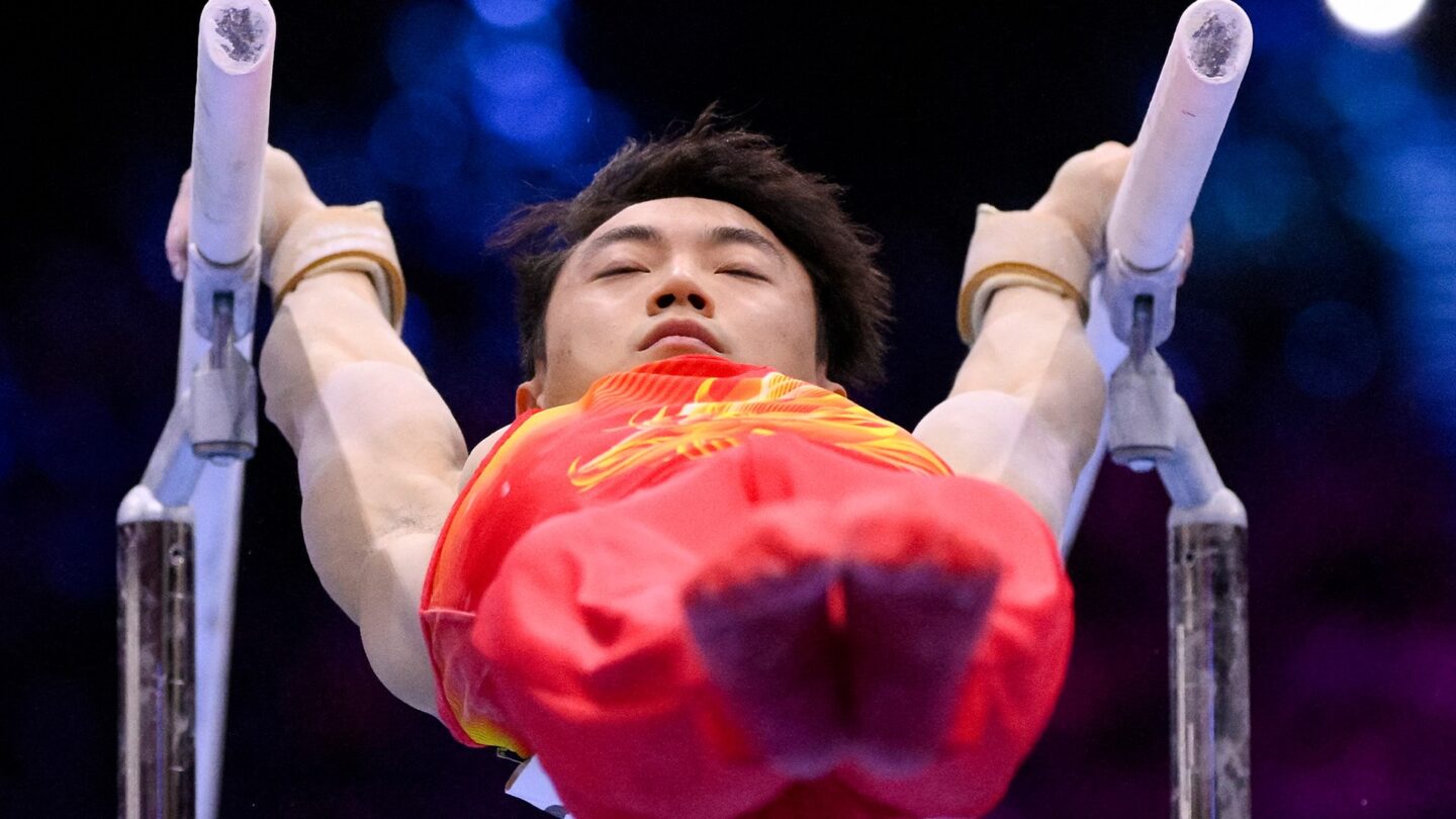 <i>NBC Olympics</i><br/>Zou Jingyuan competes on parallel bars