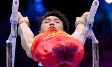 Zou Jingyuan competes on parallel bars