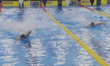 Two swimmers race side by side