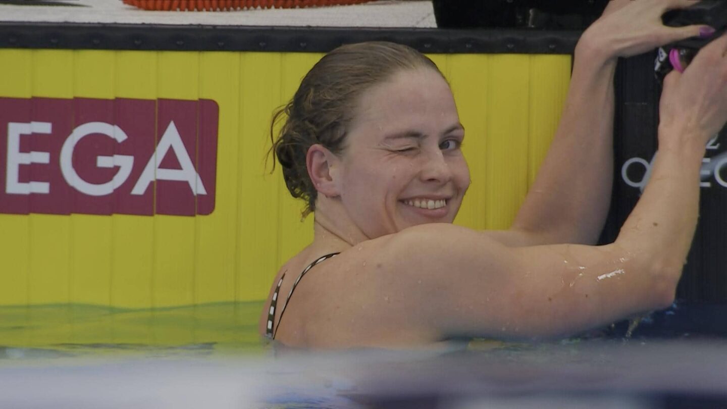 <i>NBC Olympics</i><br/>Katharine Berkoff winks at the camera while in the pool