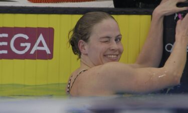 Katharine Berkoff winks at the camera while in the pool