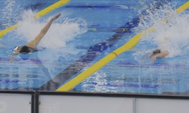 Two swimmers race side by side